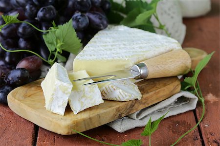 Soft brie cheese with sweet grapes on a wooden board Stock Photo - Budget Royalty-Free & Subscription, Code: 400-07714066