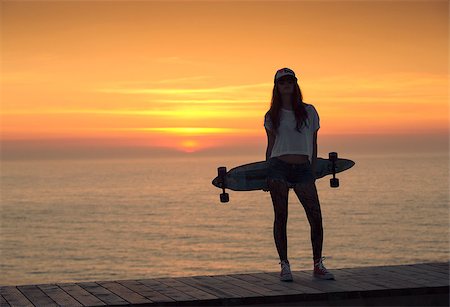 Beautiful and fashion young woman posing with a skateboard Stock Photo - Budget Royalty-Free & Subscription, Code: 400-07714358
