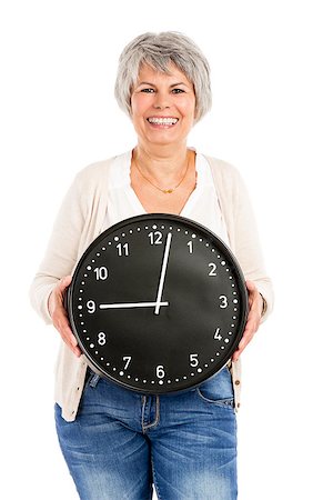 senior clock - Elderly woman holding a clock, isoalted on white background Stock Photo - Budget Royalty-Free & Subscription, Code: 400-07714441
