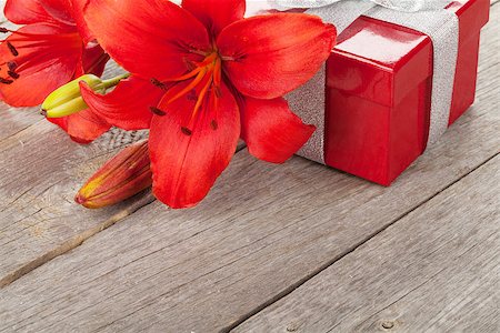 simsearch:400-07662543,k - Red lily flower and gift box on wooden table with copy space Stock Photo - Budget Royalty-Free & Subscription, Code: 400-07714935