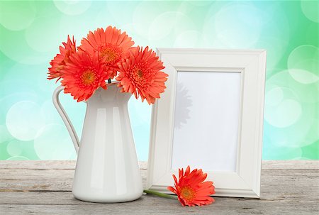 simsearch:400-07662543,k - Orange gerbera flowers and photo frame on wooden table with sunny bokeh background Stock Photo - Budget Royalty-Free & Subscription, Code: 400-07714930