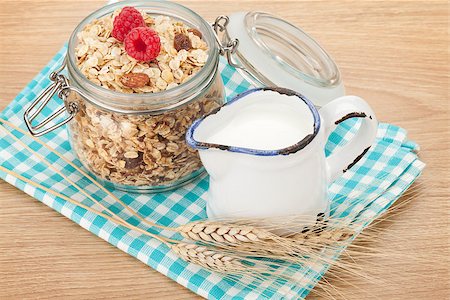 porridge and berries - Healty breakfast with muesli, berries and milk. On wooden table Stock Photo - Budget Royalty-Free & Subscription, Code: 400-07714954