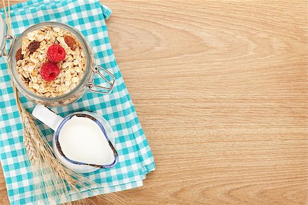 porridge and berries - Healty breakfast with muesli, berries and milk. View from above on wooden table with copy space Stock Photo - Budget Royalty-Free & Subscription, Code: 400-07714955