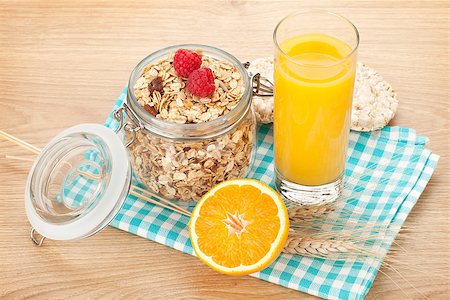simsearch:400-05735704,k - Healty breakfast with muesli, berries and orange juice. View from above on wooden table with copy space Photographie de stock - Aubaine LD & Abonnement, Code: 400-07714956