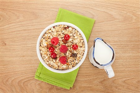 porridge and fruit - Healty breakfast with muesli, berries and milk. View from above on wooden table Stock Photo - Budget Royalty-Free & Subscription, Code: 400-07714958