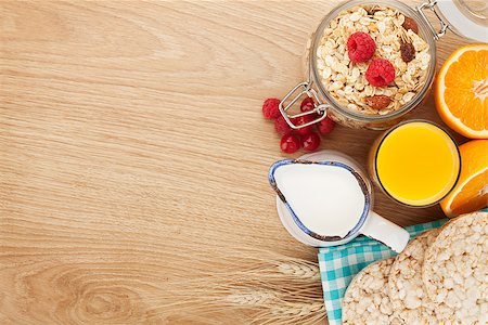 porridge and berries - Healty breakfast with muesli, berries and orange juice. View from above on wooden table with copy space Stock Photo - Budget Royalty-Free & Subscription, Code: 400-07714953