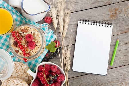 simsearch:400-08113690,k - Healty breakfast with muesli, berries and orange juice. View from above on wooden table with notepad for copy space Stock Photo - Budget Royalty-Free & Subscription, Code: 400-07714969
