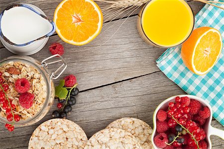 simsearch:400-08113690,k - Healty breakfast with muesli, berries and orange juice. View from above on wooden table with copy space Stock Photo - Budget Royalty-Free & Subscription, Code: 400-07714971
