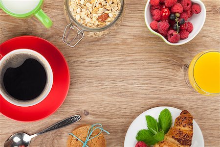 porridge and berries - Healty breakfast with muesli, berries, orange juice, coffee and croissant. View from above on wooden table with copy space Stock Photo - Budget Royalty-Free & Subscription, Code: 400-07714987