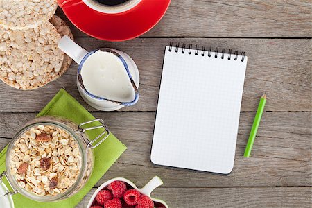 simsearch:400-04393799,k - Healty breakfast with muesli, berries and milk. View from above on wooden table with notepad for copy space Fotografie stock - Microstock e Abbonamento, Codice: 400-07715003
