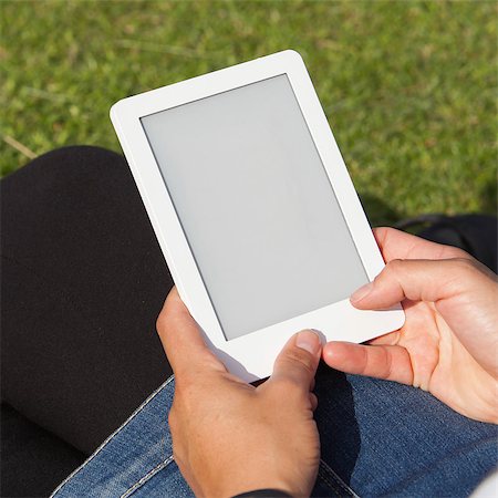 Woman reading ebook on the grass, square image Stock Photo - Budget Royalty-Free & Subscription, Code: 400-07715189