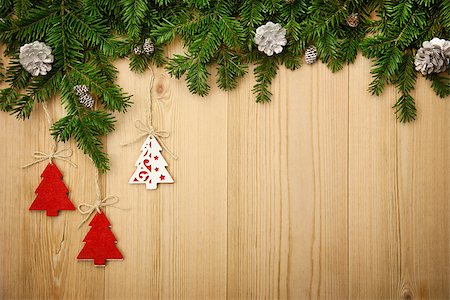 Christmas background with fresh firtree, decorative handmade trees and cones on wood Stock Photo - Budget Royalty-Free & Subscription, Code: 400-07715536