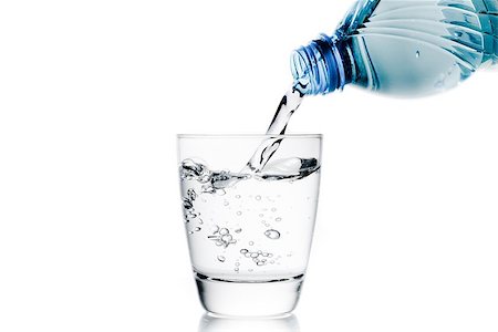 simsearch:400-06918144,k - pouring a glass with water trough little blue bottle and space for text on white background Stock Photo - Budget Royalty-Free & Subscription, Code: 400-07715587