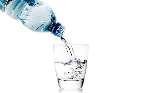 simsearch:400-06918144,k - pouring a glass with water trough little blue bottle on white background Stock Photo - Budget Royalty-Free & Subscription, Code: 400-07715588