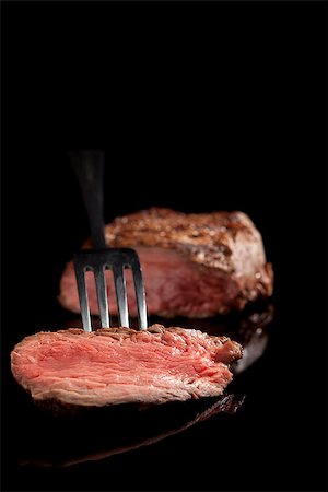 delicious medium rare sliced steak with fork Stock Photo - Budget Royalty-Free & Subscription, Code: 400-07715724