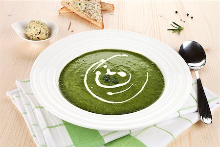 simsearch:400-07298426,k - Spinach soup in white plate on wooden table, toast bread and herbal butter in bowl in background. Stock Photo - Budget Royalty-Free & Subscription, Code: 400-07715759