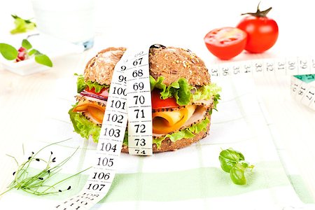 simsearch:400-04354594,k - Sandwich with fresh vegetables and cheese and measuring tape wrapped around it on table with fresh herbs. Stock Photo - Budget Royalty-Free & Subscription, Code: 400-07715750
