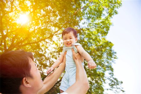 simsearch:400-07715953,k - father raising his little smiling son  up high Stock Photo - Budget Royalty-Free & Subscription, Code: 400-07715955