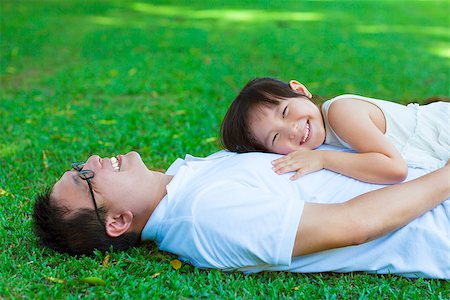 simsearch:400-07715953,k - father and daughter lying on a meadow in the park Stock Photo - Budget Royalty-Free & Subscription, Code: 400-07715958