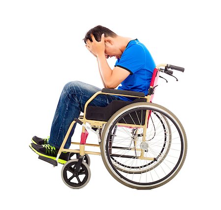 simsearch:400-07987656,k - upset  and handicapped man sitting on a wheelchair Stock Photo - Budget Royalty-Free & Subscription, Code: 400-07715992