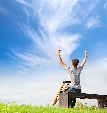 Injured Man raise hands and  sitting on a bench with Crutches Stock Photo - Budget Royalty-Free & Subscription, Code: 400-07716017