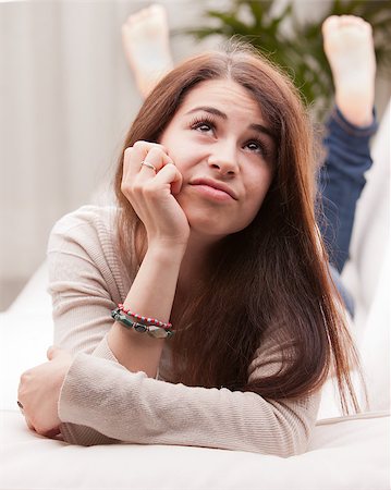 girl wondering something that could happen on a sofa or somewhere else in her life or in the world Stockbilder - Microstock & Abonnement, Bildnummer: 400-07716435