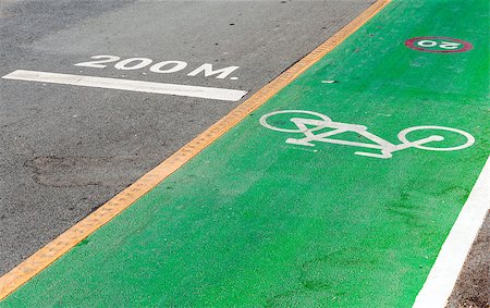 Bicycle lane near the running lane of urban park. Stock Photo - Budget Royalty-Free & Subscription, Code: 400-07716472