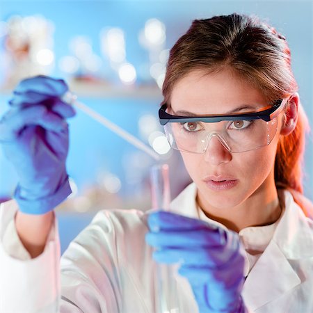 simsearch:628-02062769,k - Focused young life science professional pipetting solution into the glass cuvette. Lens focus on the researcher's eye. Stock Photo - Budget Royalty-Free & Subscription, Code: 400-07716640