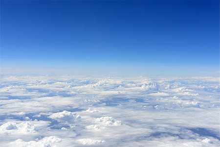 Blue sky and clouds. Top view of aircraft Foto de stock - Super Valor sin royalties y Suscripción, Código: 400-07716785