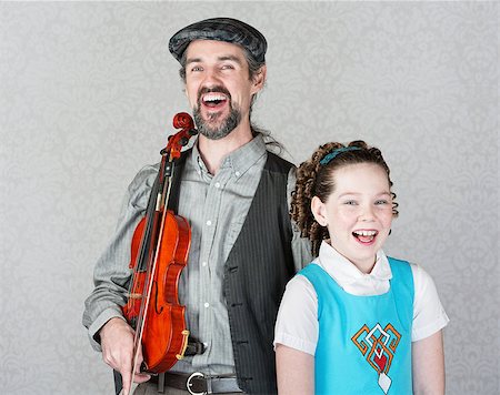 fiddler - Laughing Irish folk fiddle player with happy child Stock Photo - Budget Royalty-Free & Subscription, Code: 400-07717682