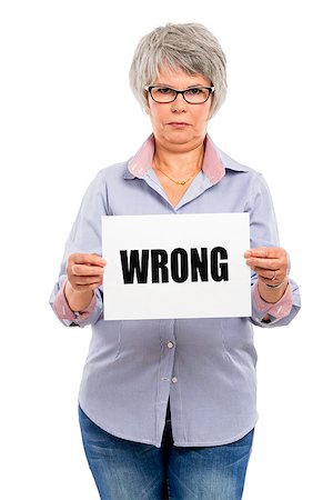Elderly woman holding a paper card  with the word Wrong Stock Photo - Budget Royalty-Free & Subscription, Code: 400-07718369