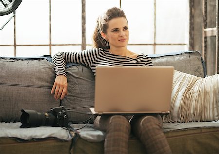 photographer laptop - Thoughtful young woman with modern dslr photo camera using laptop in loft apartment Stock Photo - Budget Royalty-Free & Subscription, Code: 400-07718503