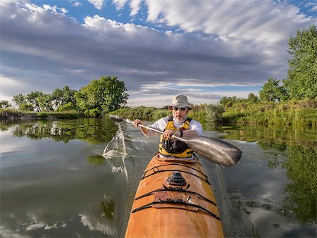 simsearch:400-07795226,k - a bow view of a senior male paddling a home-built wooden sea kayak on a lake in Colorado Foto de stock - Royalty-Free Super Valor e Assinatura, Número: 400-07718852