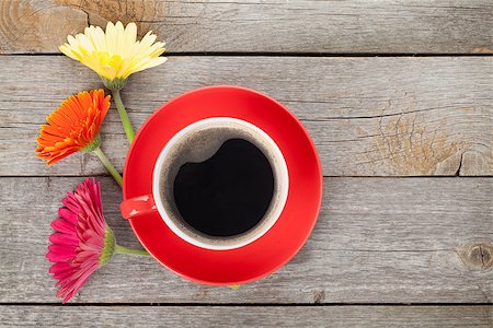 Cup of coffee and gerbera flowers on wooden table Stock Photo - Budget Royalty-Free & Subscription, Code: 400-07719039