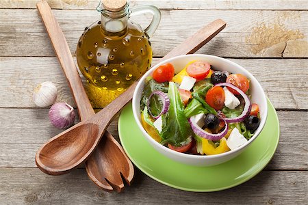 simsearch:400-06485512,k - Fresh healthy salad on wooden table and kitchen utensils Stock Photo - Budget Royalty-Free & Subscription, Code: 400-07719236