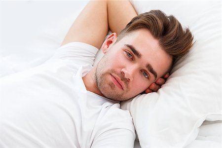 simsearch:400-07680948,k - Home. Handsome guy in the bed Stock Photo - Budget Royalty-Free & Subscription, Code: 400-07719760