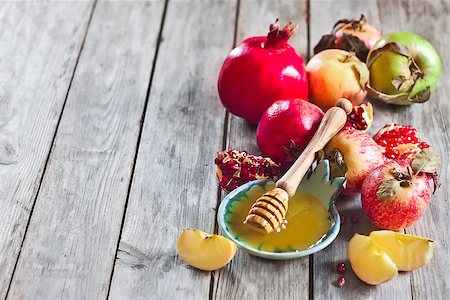 simsearch:400-09080023,k - Pomegranate, apple and honey, traditional food of jewish New Year celebration, Rosh Hashana. Selective focus. Copyspace background Stock Photo - Budget Royalty-Free & Subscription, Code: 400-07719951