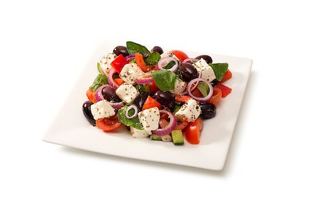 Traditional Greek salad in a  white salad bowl on white background Stock Photo - Budget Royalty-Free & Subscription, Code: 400-07712781