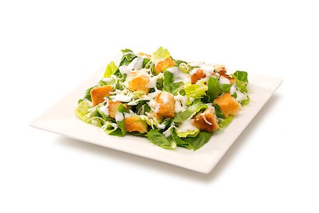 romaine lettuce leaf - Traditional classic Caesar salad in a deep white plate Stock Photo - Budget Royalty-Free & Subscription, Code: 400-07712782