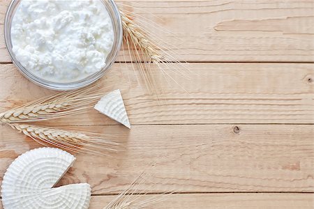 Tzfat cheese and cottage cheese with wheat grains. Symbols of judaic holiday Shavuot. Copy space background. Stock Photo - Budget Royalty-Free & Subscription, Code: 400-07713420