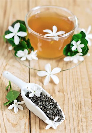 Green tea with jasmine blossom in cup and ceramic scoop. Selective focus. Stock Photo - Budget Royalty-Free & Subscription, Code: 400-07713444