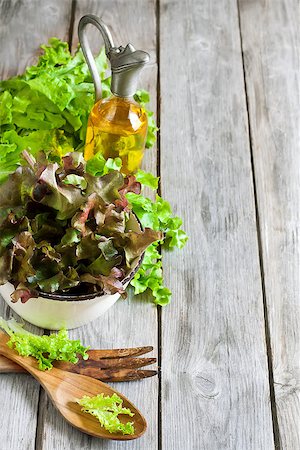 simsearch:400-06485512,k - Green salad lettuce with olive oil on old wooden table. Copy space background. Stock Photo - Budget Royalty-Free & Subscription, Code: 400-07713453