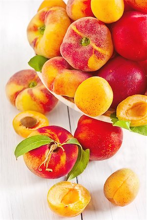 simsearch:400-07667203,k - Ripe apricots, nectarines and saturn peaches on ceramic holder. Selective focus. Stock Photo - Budget Royalty-Free & Subscription, Code: 400-07713490