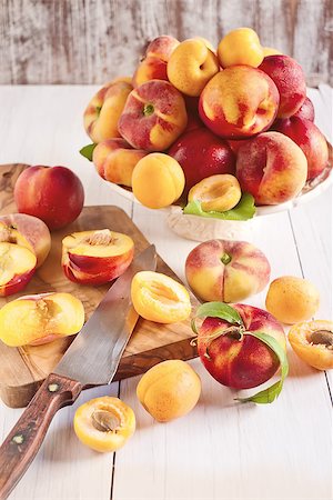 simsearch:400-07667203,k - Ripe apricots, nectarines and saturn peaches on ceramic holder. Selective focus. Stock Photo - Budget Royalty-Free & Subscription, Code: 400-07713492