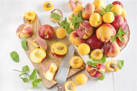 simsearch:400-07667203,k - Ripe apricots, nectarines and saturn peaches on ceramic holder. Selective focus. Stock Photo - Budget Royalty-Free & Subscription, Code: 400-07713493