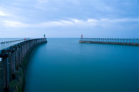 Entrance to the harbour at Whitby, North Yorkshire with its two breakwaters and navigation lights that are extensions to the original stone piers Stock Photo - Budget Royalty-Free & Subscription, Code: 400-07724145