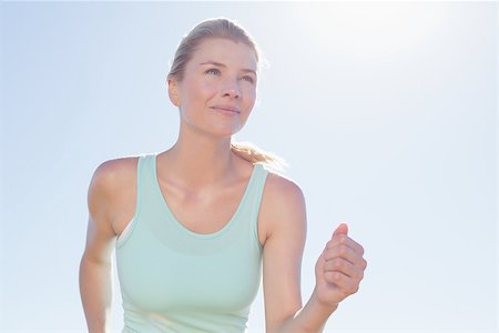 Fit woman jogging and smiling on a sunny day Stock Photo - Budget Royalty-Free & Subscription, Code: 400-07724206