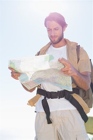 people on trail with map - Handsome hiker reading map on mountain trail on a sunny day Stock Photo - Budget Royalty-Free & Subscription, Code: 400-07724212