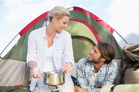 Attractive happy couple cooking on camping stove on a sunny day Stock Photo - Budget Royalty-Free & Subscription, Code: 400-07724278