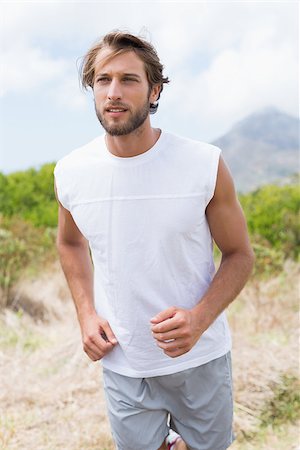 simsearch:400-08017381,k - Attractive man jogging on mountain trail on a sunny day Photographie de stock - Aubaine LD & Abonnement, Code: 400-07724289